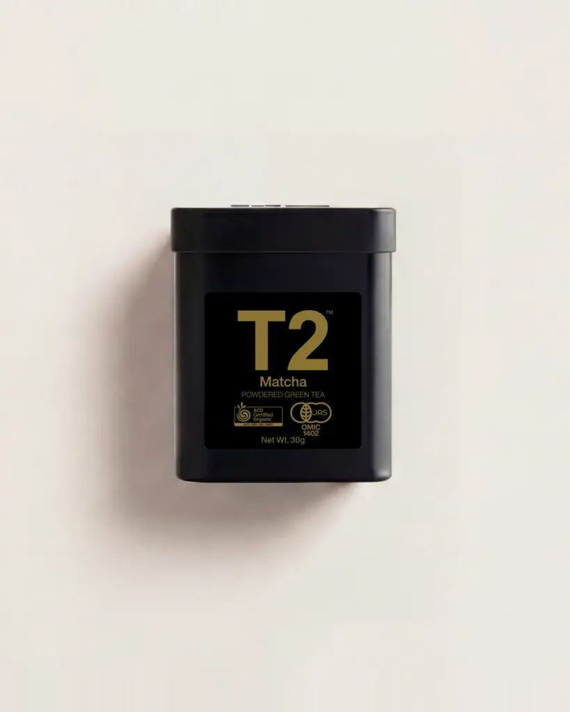 Black T2 Matcha powdered green tea tin with gold label on an off-white background