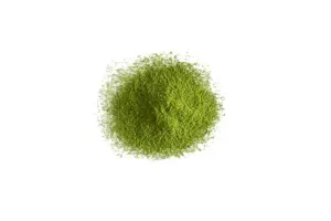Overhead view of a mound of fine green matcha powder on a white background