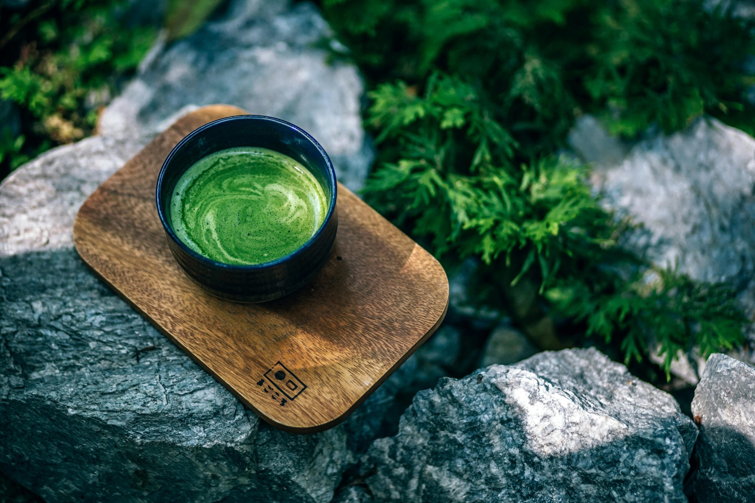 Home A cup of matcha on a wooden plank