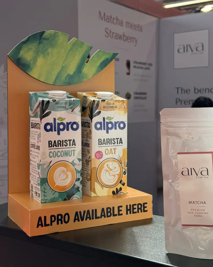 Aiya matcha pouch beside cartons of coconut and oat drinks