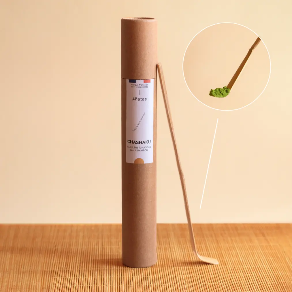 Anatae bamboo chashaku leaning against its labeled cardboard tube, with inset showing spoon holding matcha