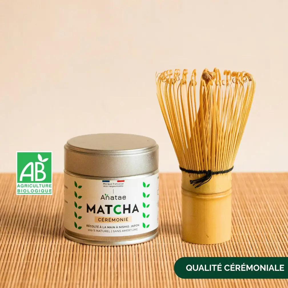 Anatae ceremonial matcha tin beside bamboo chasen on woven mat