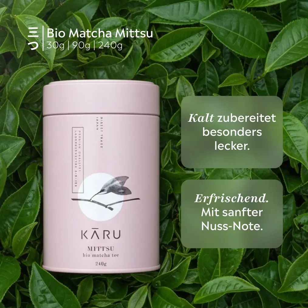 Pink Matcha Kāru Bio Matcha Mittsu 240 g tin surrounded by green tea leaves