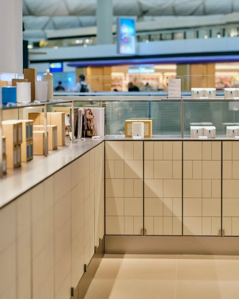 Coffee packages, boxes, and books arranged on a tiled retail counter