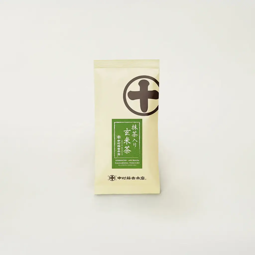 Cream-colored foil tea bag with a green label reading Genmaicha with Matcha and a brown circular crest, standing upright on a white background