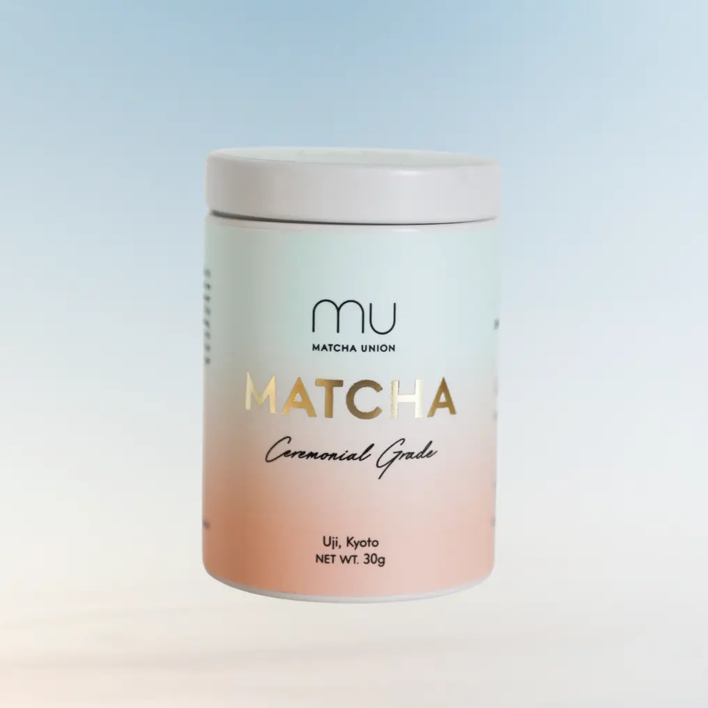 Front view of a Matcha Union Ceremonial Grade matcha tin with a pale blue and pink label