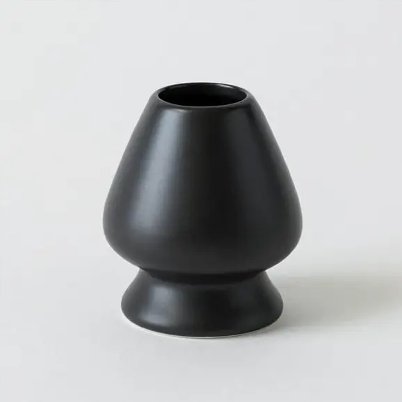 Black porcelain chasen stand with a rounded body and flared base
