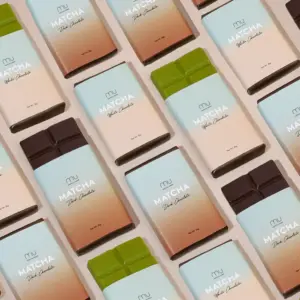 Pattern of wrapped Matcha Union chocolate bars with green and dark brown squares exposed