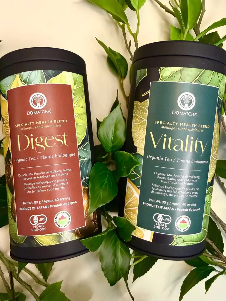 Do Matcha Digest and Vitality tea canisters displayed among green leaves