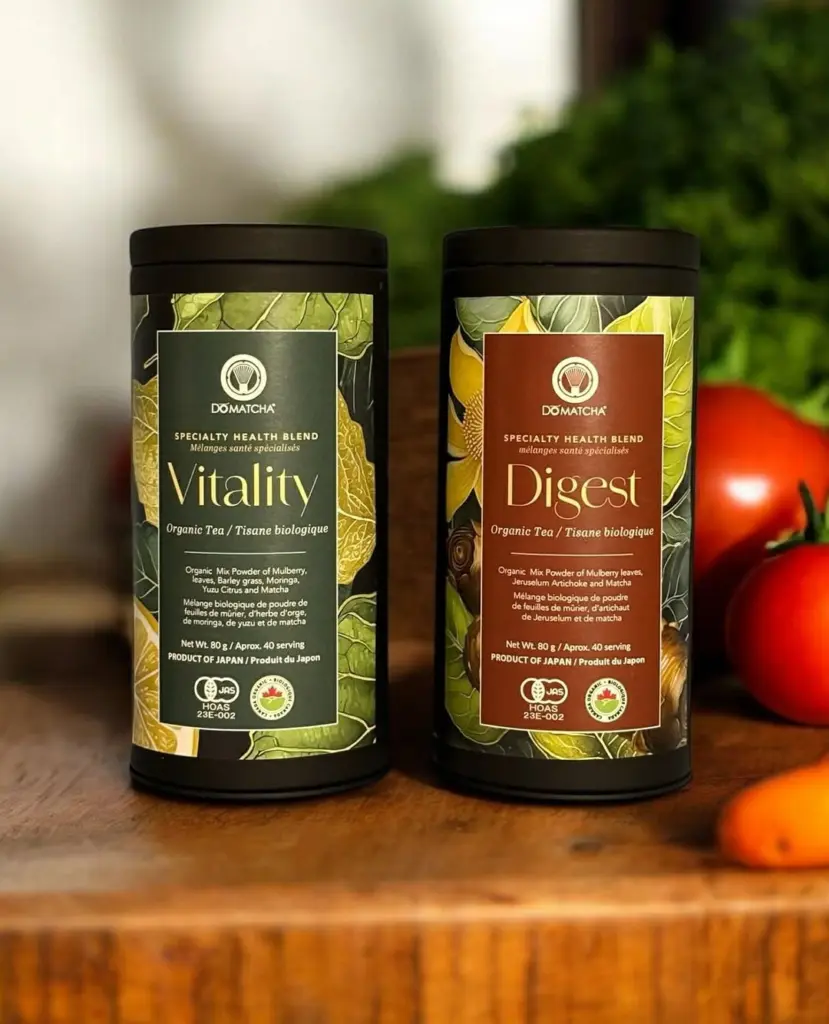 Do Matcha Vitality and Digest tins on a wooden board with tomatoes and leafy greens