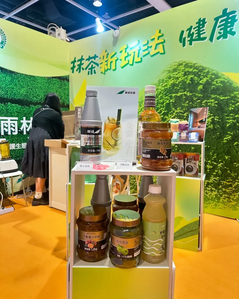 Bottles and jars of drink ingredients arranged on a white display stand