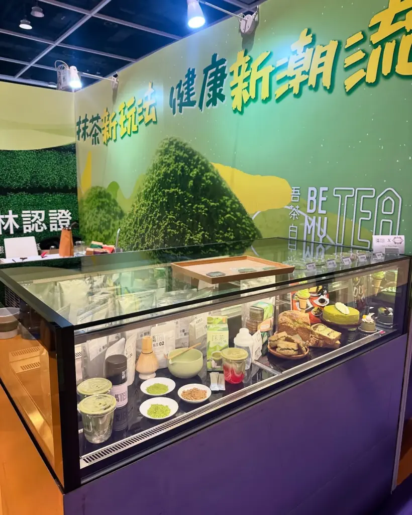 Glass counter filled with green tea drinks, powders, packages, and desserts
