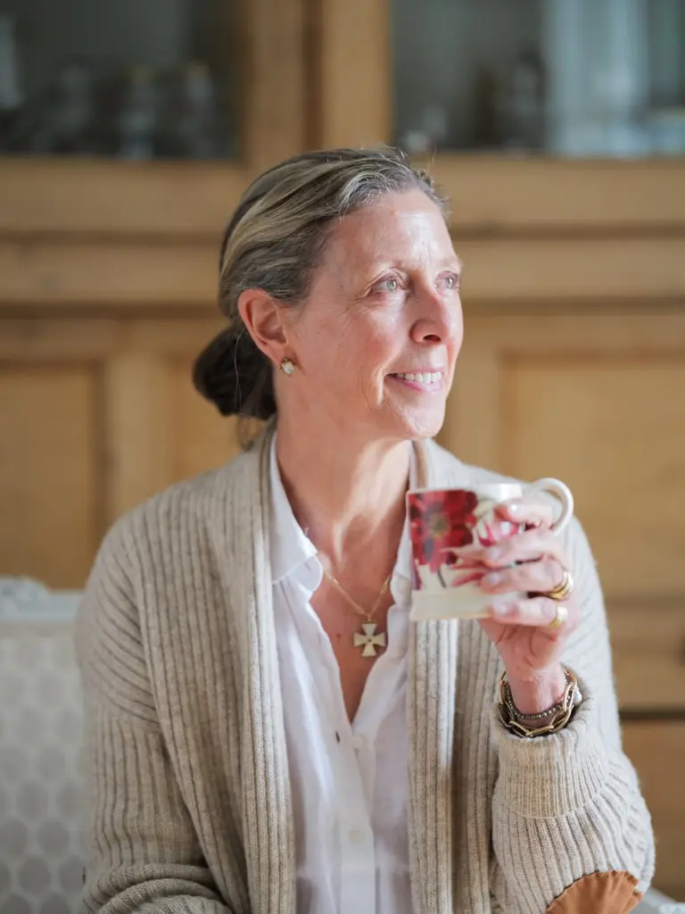 Smiling woman holding a floral teacup