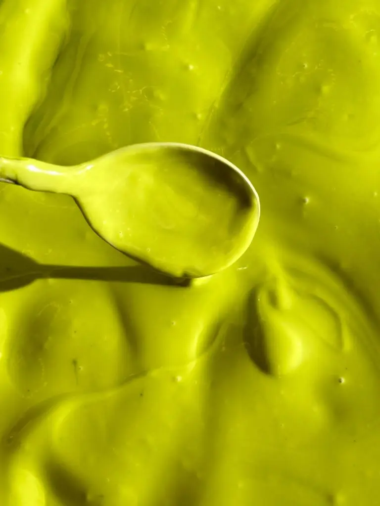 Spoon resting in a thick, glossy green mixture