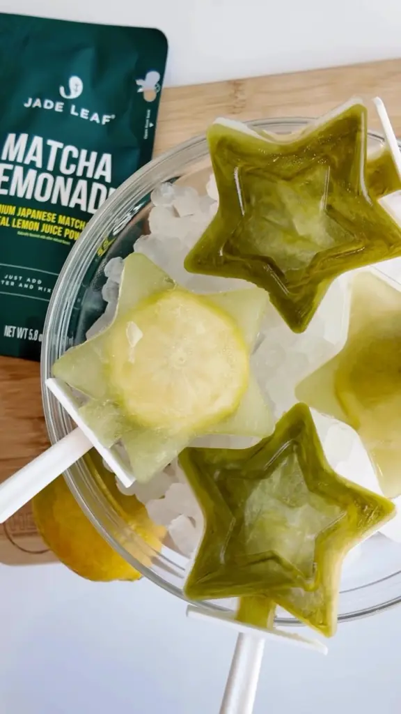Green and pale yellow star-shaped frozen pops arranged over crushed ice