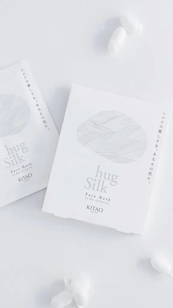 Two white Kitao Hug Silk face mask packets with silk cocoons