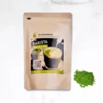 Kumiko Matcha Barista pouch beside a small mound of green powder