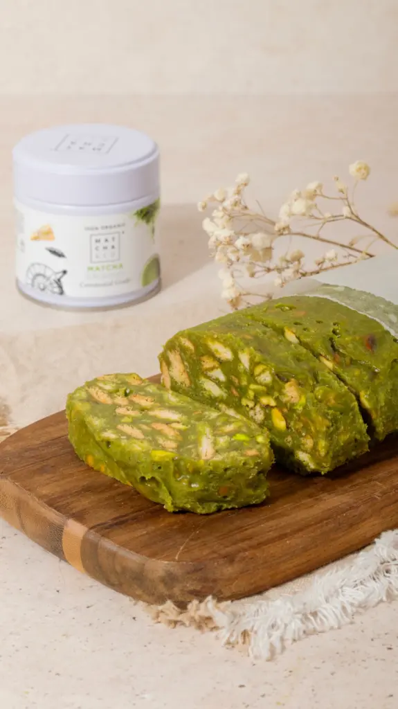 Slices of green biscuit-filled dessert on a wooden board