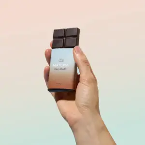 Hand holding a partially unwrapped Matcha Union dark chocolate bar