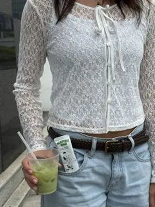 Person holding a clear cup of green iced drink with a Matcha DNA packet in their pocket
