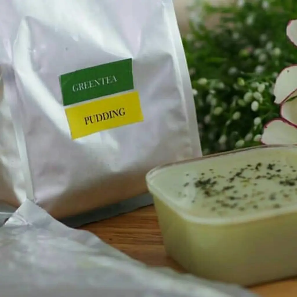 Pale green pudding beside a silver pouch labeled Green Tea Pudding