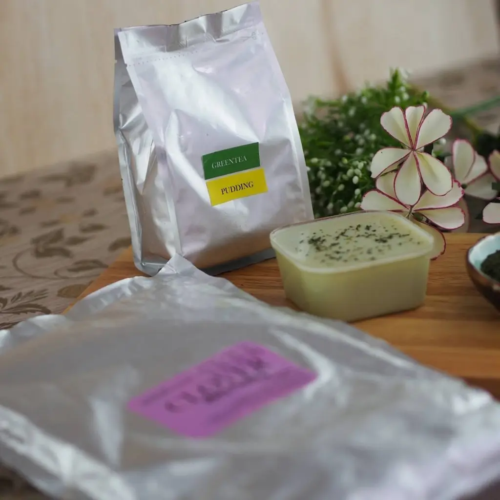 Silver Green Tea Pudding pouch beside a square container of pale green pudding