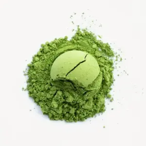 Rounded scoop of green matcha resting on a loose mound of powder