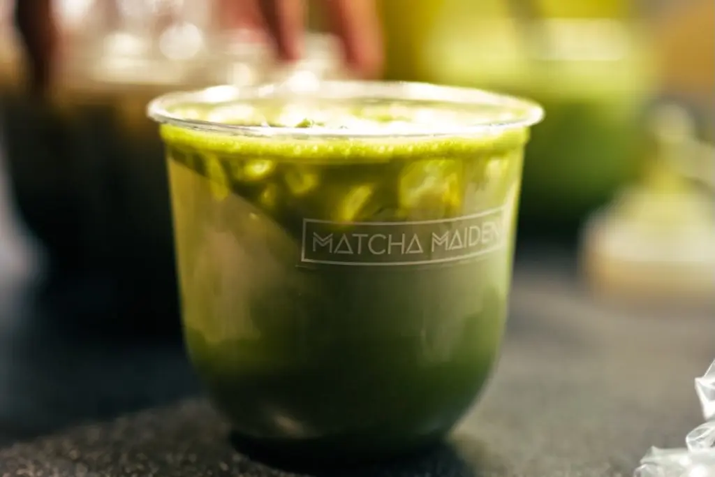 Iced green drink in a clear Matcha Maiden cup