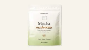 Complete front view of the Matcha & CO Matcha Mushrooms pouch on a warm ivory background