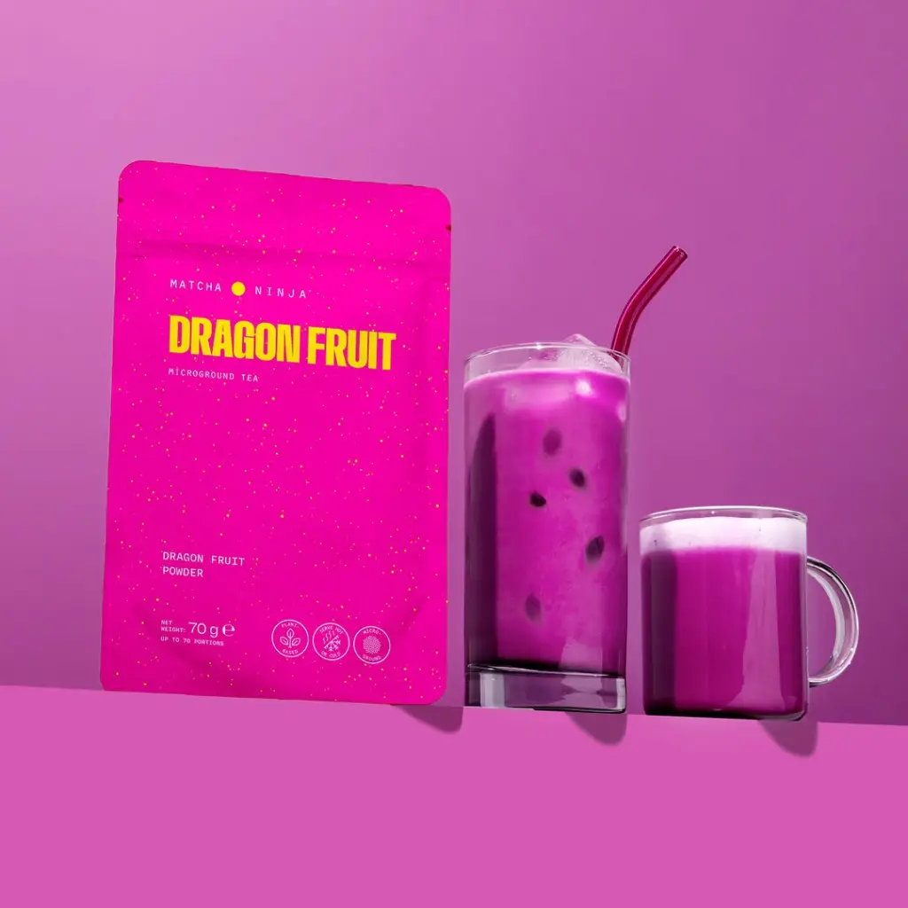 Pink Dragon Fruit tea pouch beside iced and hot magenta drinks