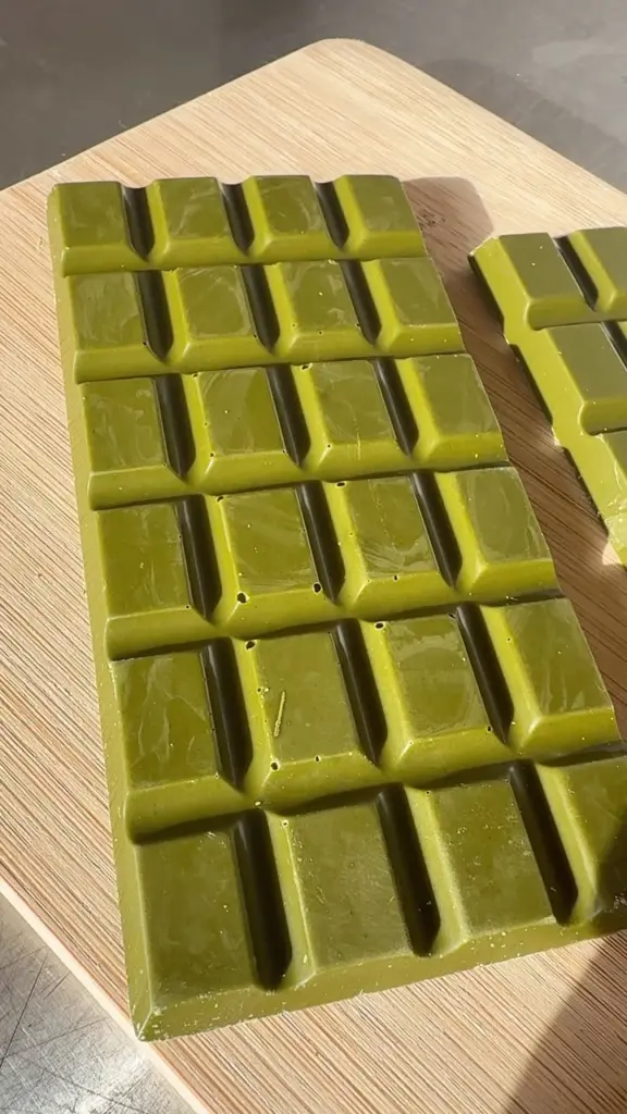 Glossy segmented green bars arranged on a wooden board