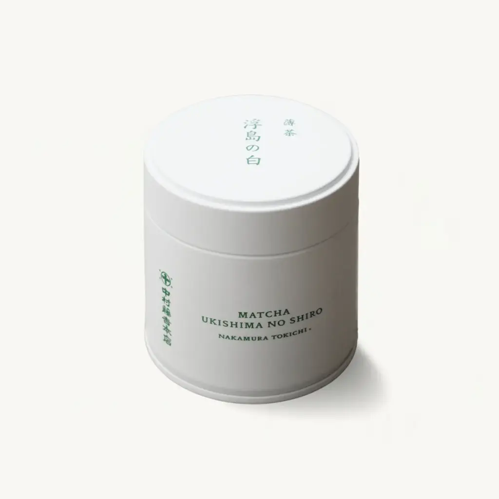 White cylindrical matcha tin with green Japanese and Latin lettering reading Matcha Ukishima no Shiro, Nakamura Tokichi, lid closed