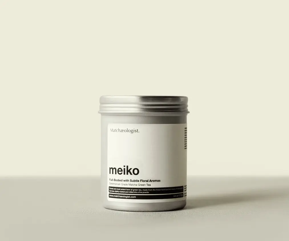 Silver Matchaeologist Meiko matcha tin with a white label on a light background