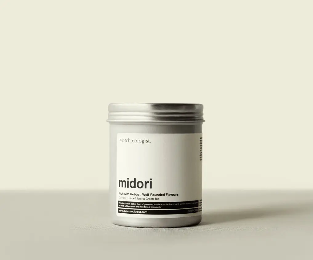 Silver container of Matchæologist Midori Culinary Matcha 100g with a white front label