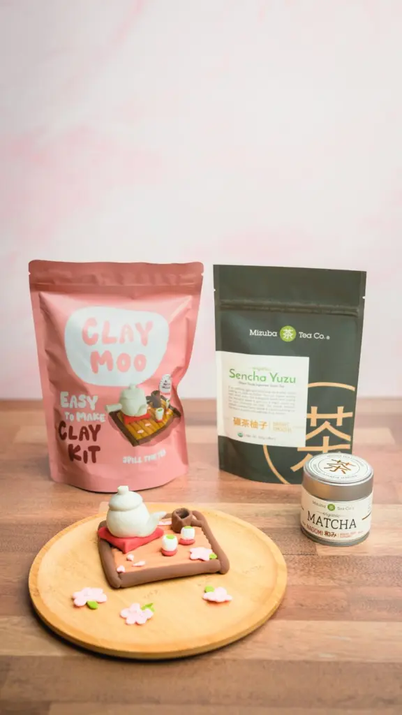 Miniature clay tea set displayed with Mizuba Matcha and Sencha Yuzu packages