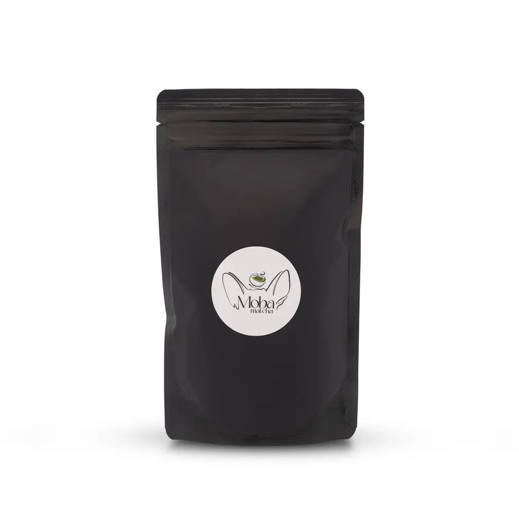 Front view of a black resealable Moba Matcha pouch with a round white logo label