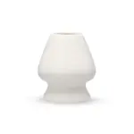 White porcelain matcha whisk holder with a rounded body and narrow base