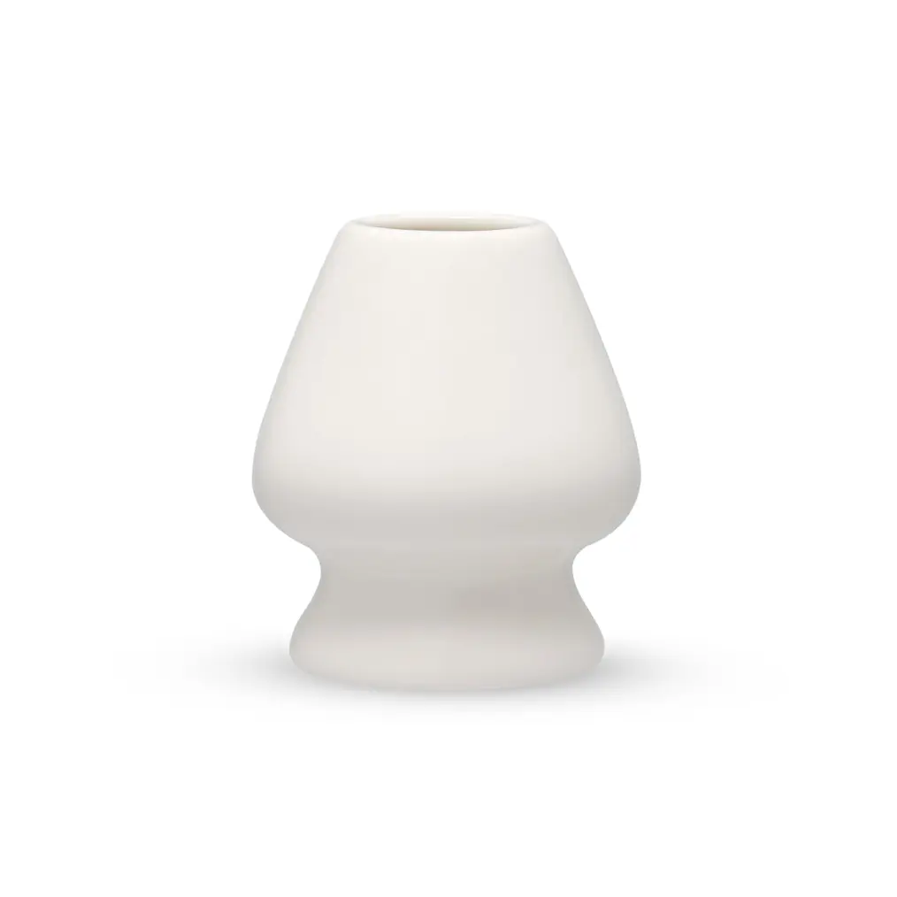 White porcelain matcha whisk holder with a rounded body and narrow base