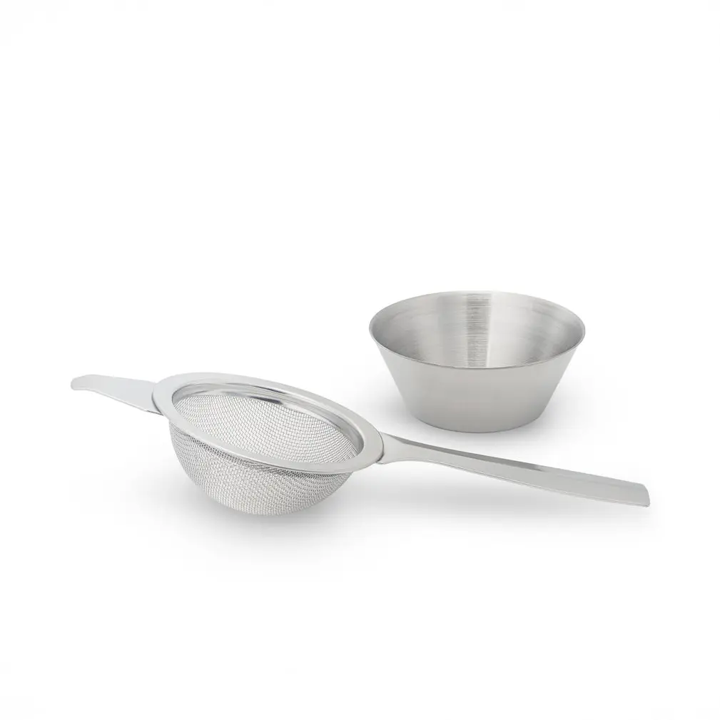 Fine-mesh matcha sifter with a long handle beside a small bowl