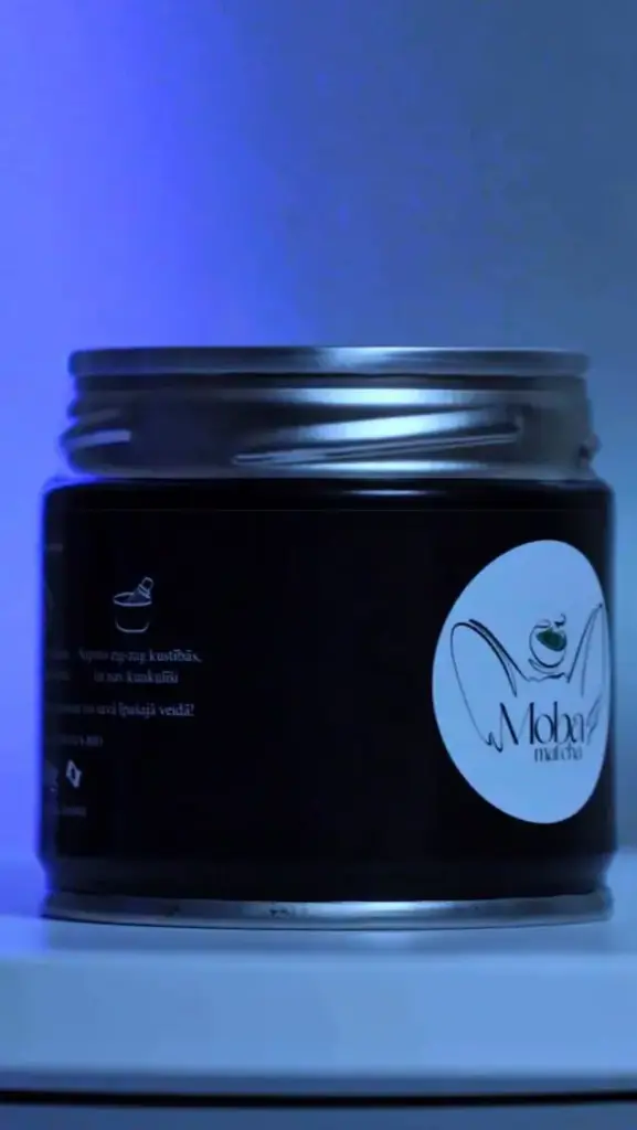 Dark Moba Matcha tin with a round logo label under blue lighting