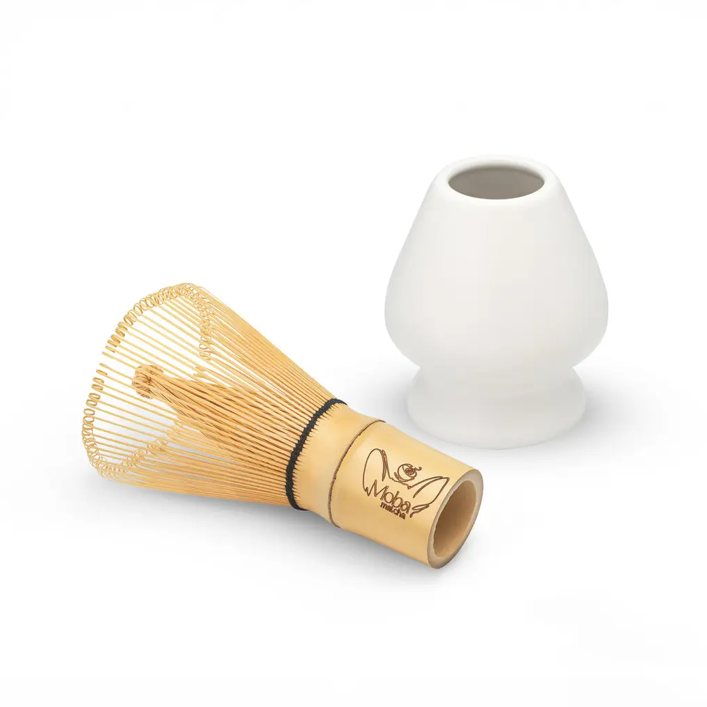 Bamboo matcha whisk beside a white hourglass-shaped holder
