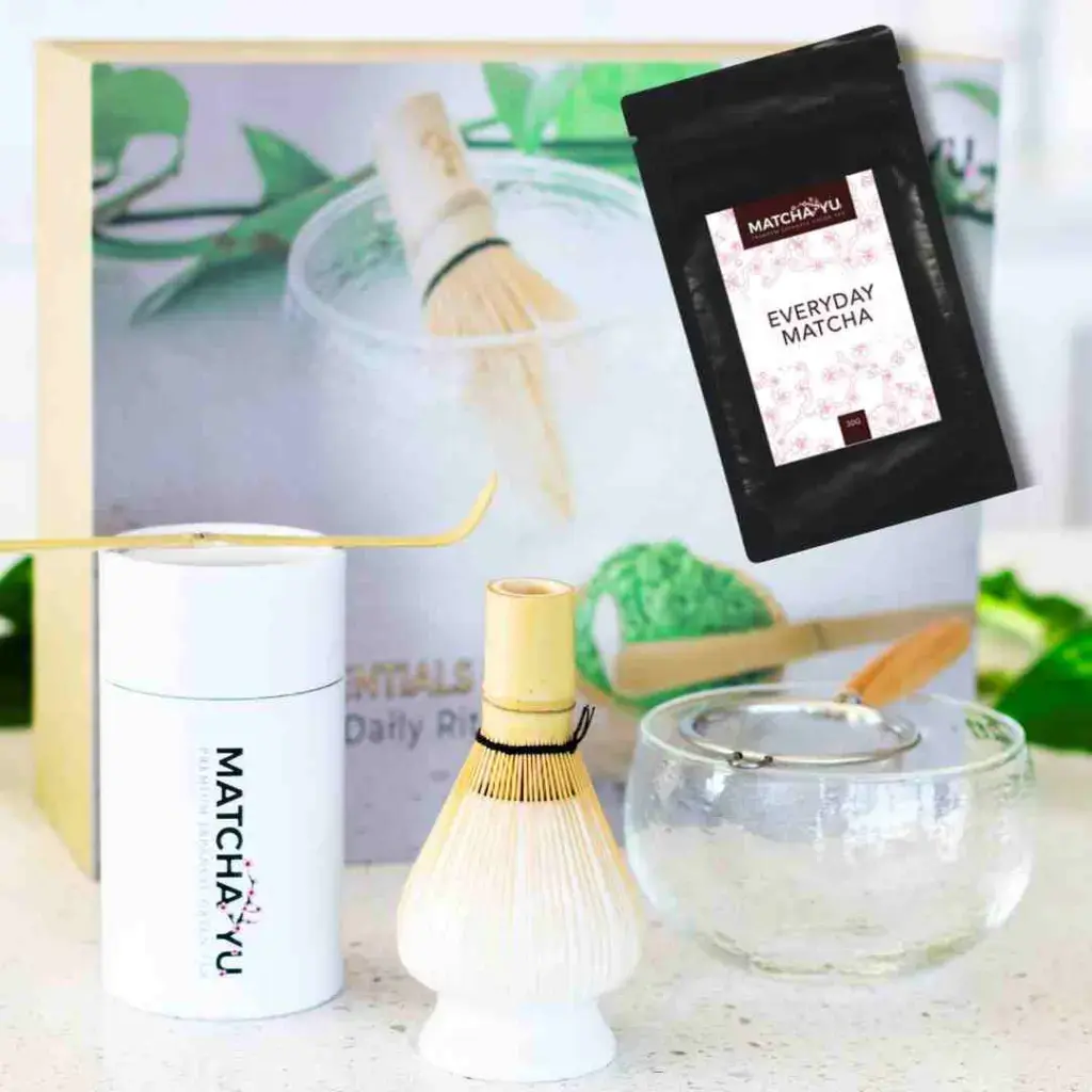 30g Everyday Matcha pouch shown above Matcha Yu tea preparation tools, a bamboo whisk, glass bowl and sieve