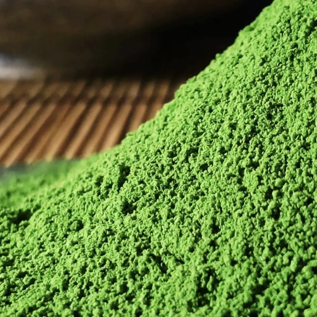 Close-up of bright green matcha powder on a wooden surface