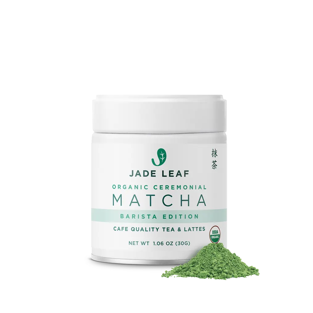 White Jade Leaf Organic Ceremonial Barista Matcha jar beside a pile of green matcha powder