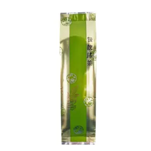 Tall silver and green tea package with Japanese text and leaf illustrations