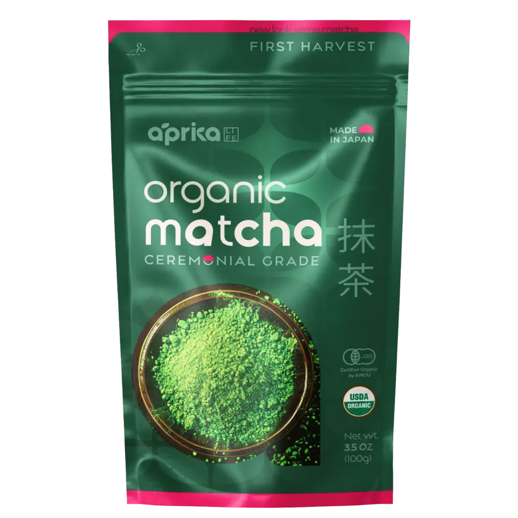 Green and pink Aprika organic ceremonial grade matcha pouch with a bowl of green powder