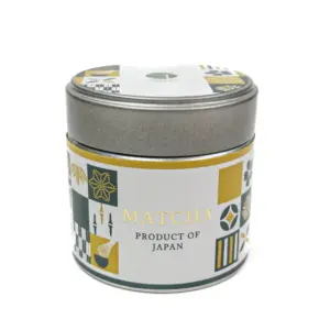 Silver matcha tin with a white, gold, and dark green patterned label reading “Matcha, Product of Japan”