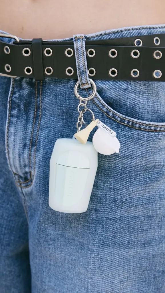 O'sulloc keychain with miniature accessories clipped to blue jeans