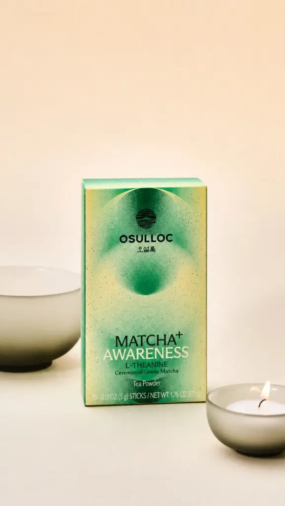 O'sulloc Matcha+ Awareness box displayed beside a lit candle