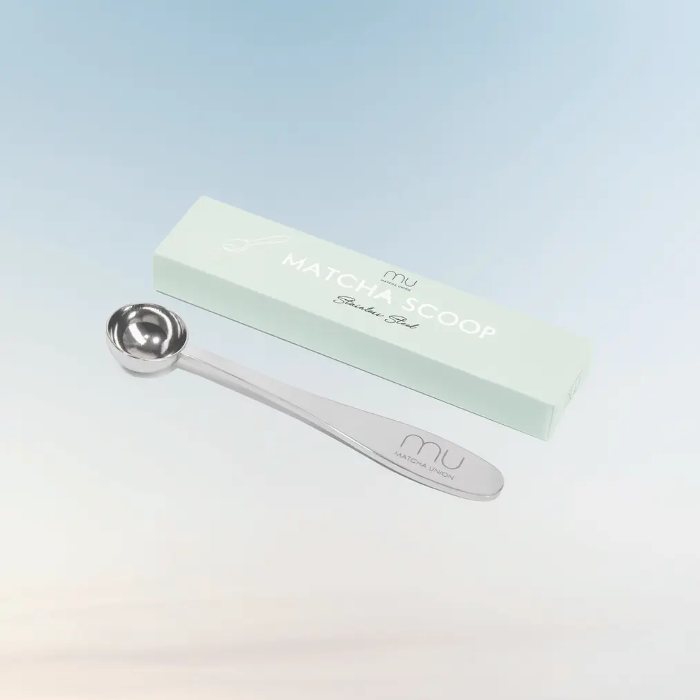 Silver Matcha Union measuring scoop beside a pale green branded box